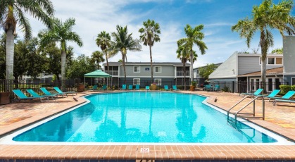 Sparkling Swimming Pool with Lounge seating and umbrellas