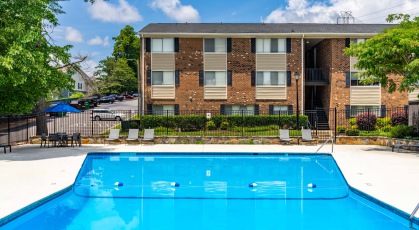 Main pool at Duke manor with lounge seating and umbrellas 