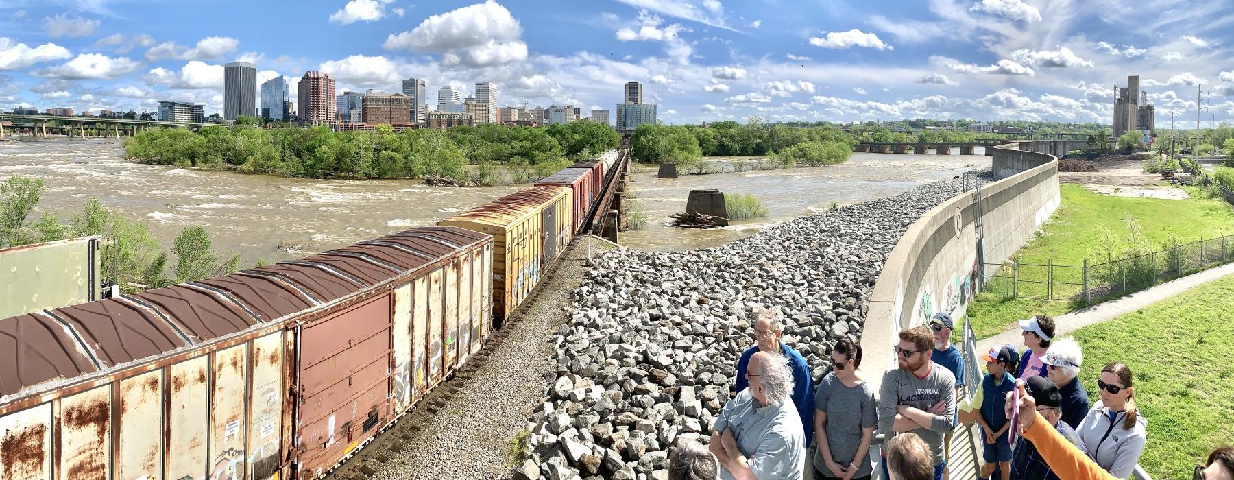a group of people looking at a train track