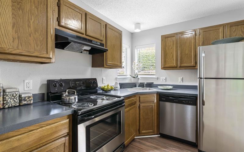 a kitchen with wooden cabinets