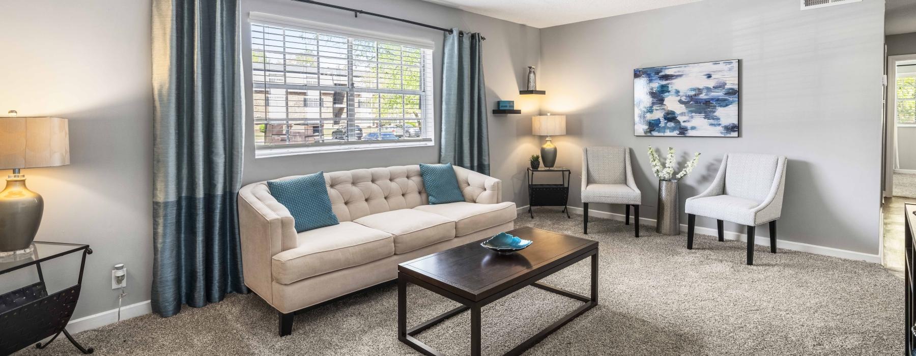 a living room with a couch and chairs