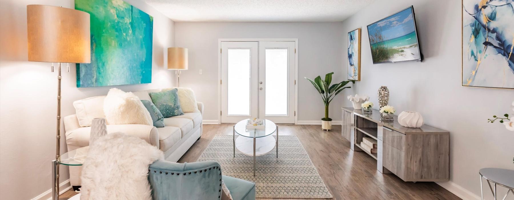 a living room with a couch, tv and a chair