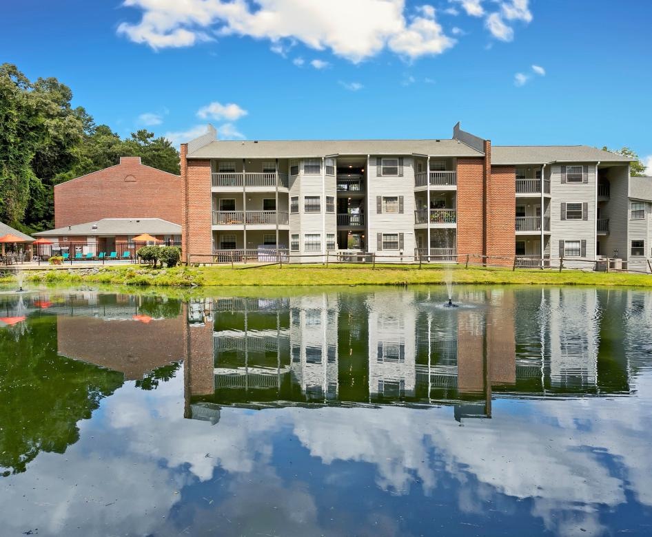 a building with a pond in front of it