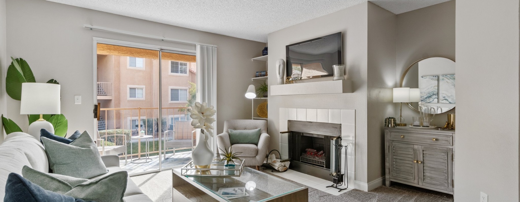 living room includes sliding glass door providing access to private patio