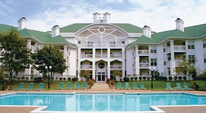 Sparkling blue pool in front of Old Buckingham Station apartments with balconies