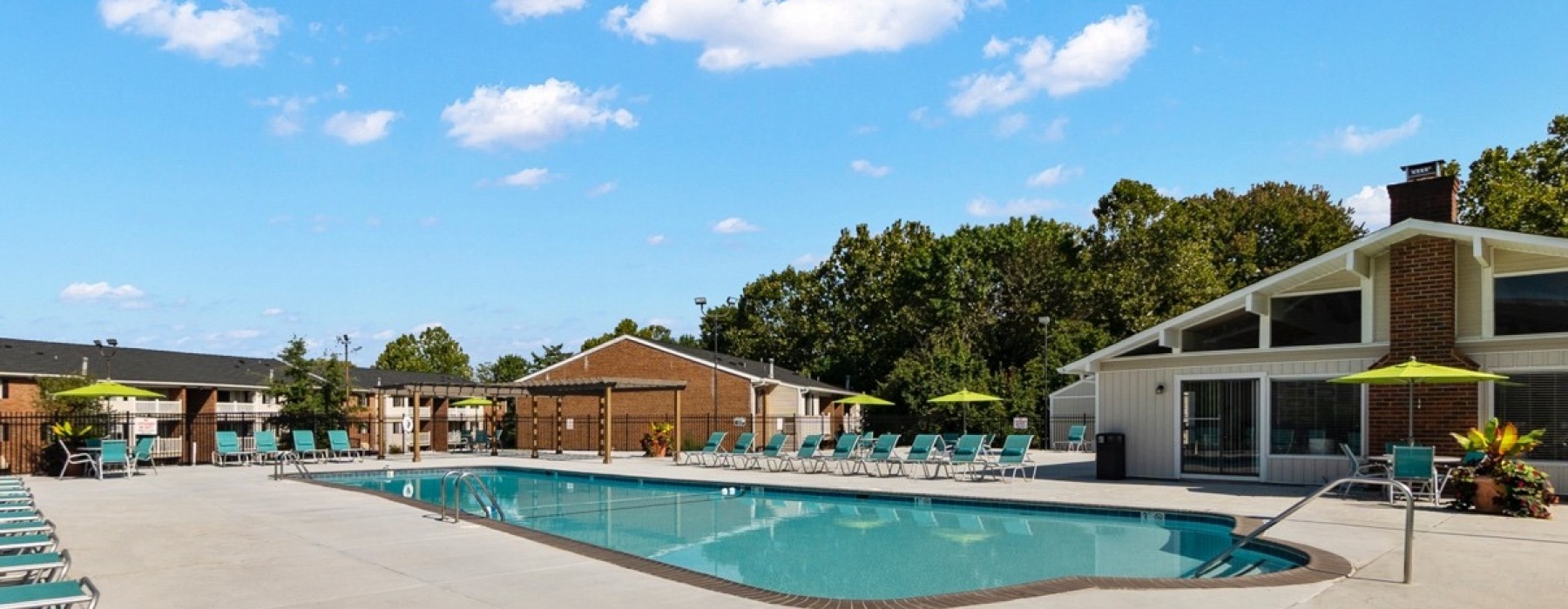 Swimming pool with lounge seating and umbrellas