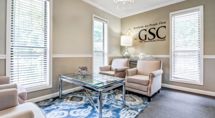 Spacious clubhouse seating area with many windows 