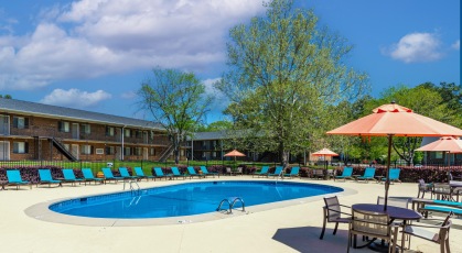 Swimming pool with lounge seating and umbrellas