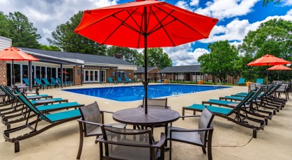 Swimming pool with lounge seating and umbrellas