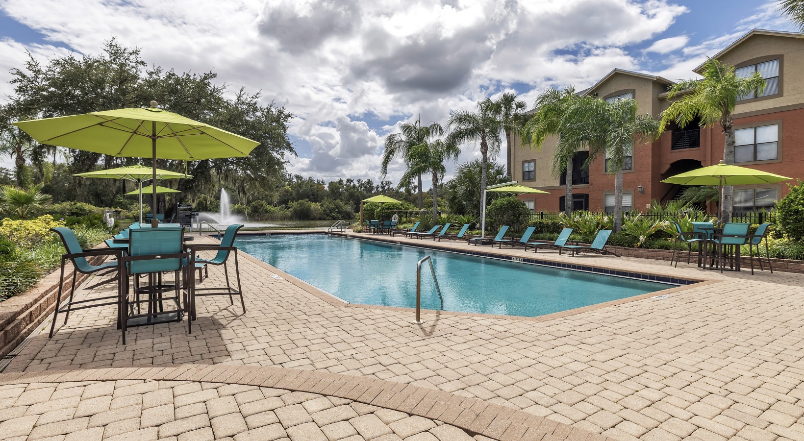 Swimming pool with lounge seating and umbrellas