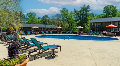 Swimming pool with lounge seating and umbrellas