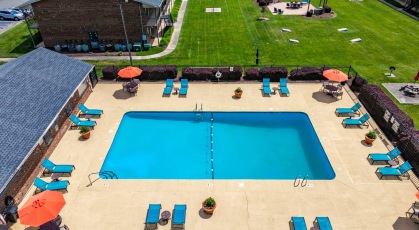 Swimming pool with umbrella shaded table and chairs