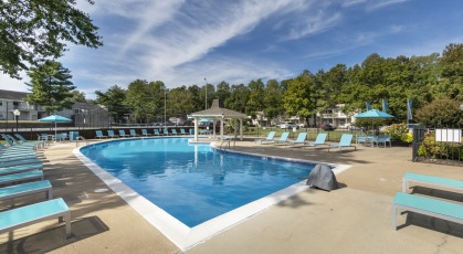Swimming pool with lounge seating and umbrellas