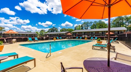 Swimming pool with umbrella shaded table and chairs