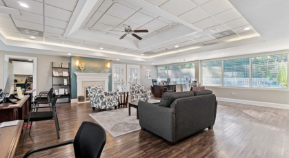 Leasing office with comfortable seating and pool views 