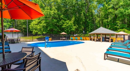 Swimming pool with cabana and lounge chairs 
