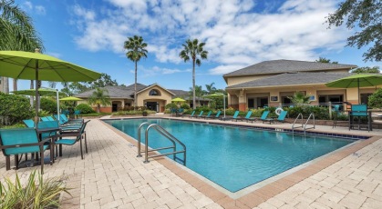 Swimming pool with lounge seating and umbrellas 