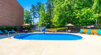Swimming pool with cabana and lounge chairs 