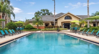 Swimming pool with lounge seating and umbrellas