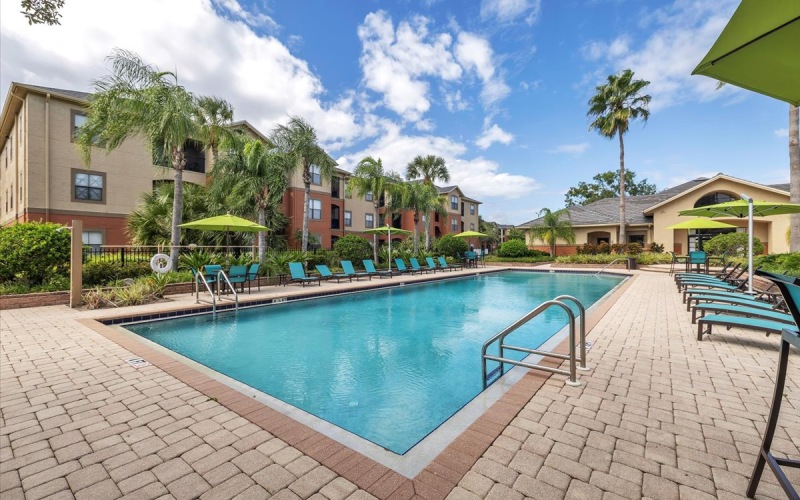 a swimming pool with chairs around it