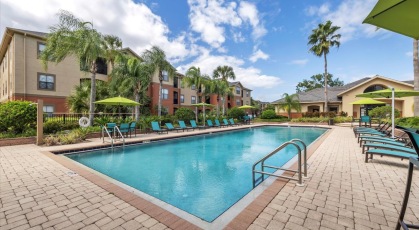 Swimming pool with lounge seating and umbrellas