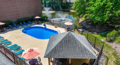 Swimming pool with cabana and lounge chairs 