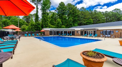 Swimming pool with lounge seating and umbrellas