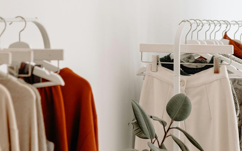 clothes on a rack near a plant