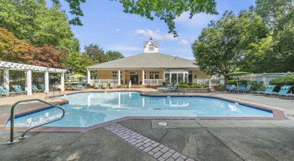 Free-form pool with sun deck and lounge chairs
