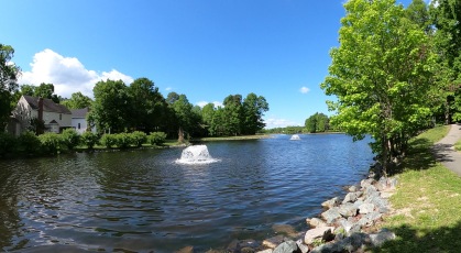 Walking path along lake with water feature