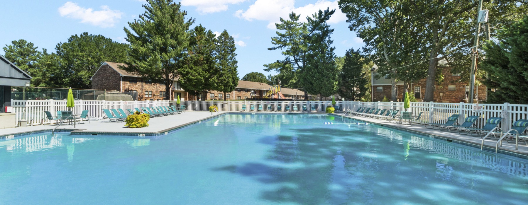 Swimming pool with lounge seating and umbrellas