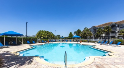 Swimming pool with lounge seating and umbrellas