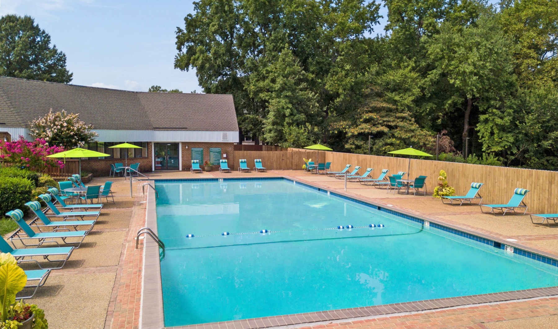 a swimming pool with chairs around it