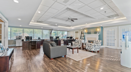 Leasing office with comfortable seating and pool views 