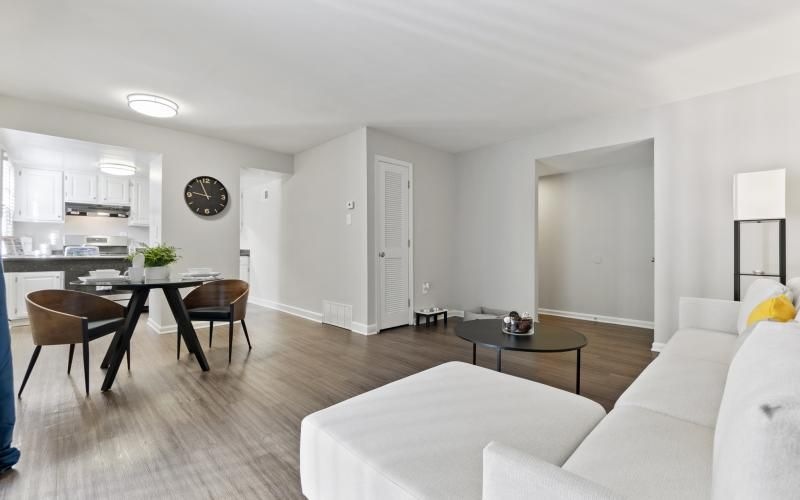 a living room with white furniture