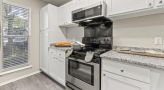 Kitchen with stainless steel appliances and built-in microwave