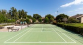 Outdoor tennis court is right next to the playground and picnic area