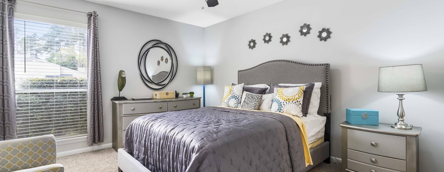 a bedroom with a bed and a fan