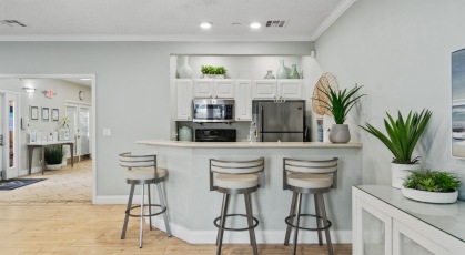 Clubhouse kitchen with stainless steel appliances and bar top seating