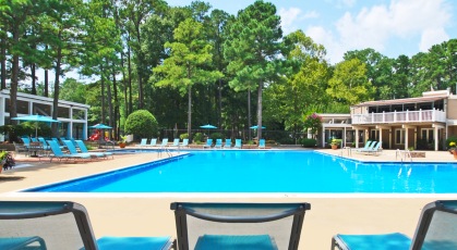 Swimming pool with lounge seating and umbrellas