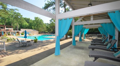 Poolside cabanas with adjustable lounge chairs