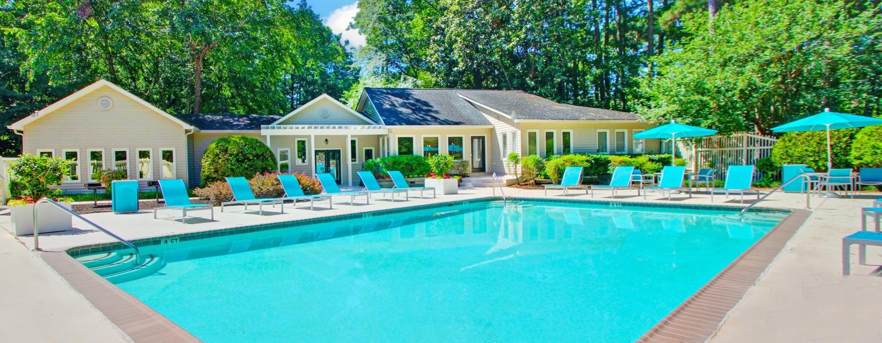 a swimming pool with chairs around it