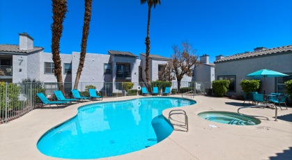 Swimming pool with lounge seating and umbrellas