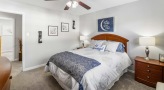 a bedroom with a fan and a bed
