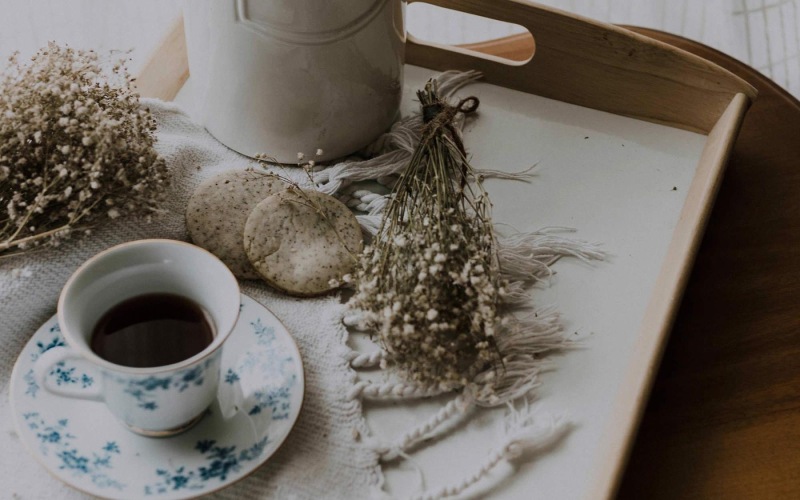 tea and cookies on a serving tray with baby's breath