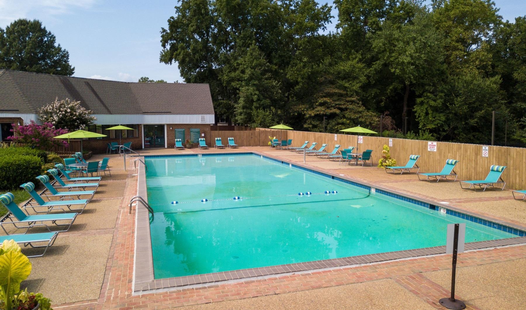 a swimming pool with chairs around it