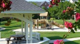 Gazebo and playground among beautifully landscaped grounds