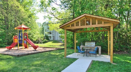 Outdoor grill stations and picnic tables by the playground