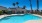 Swimming pool with lounge seating and umbrellas