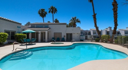 Swimming pool with lounge seating and umbrellas